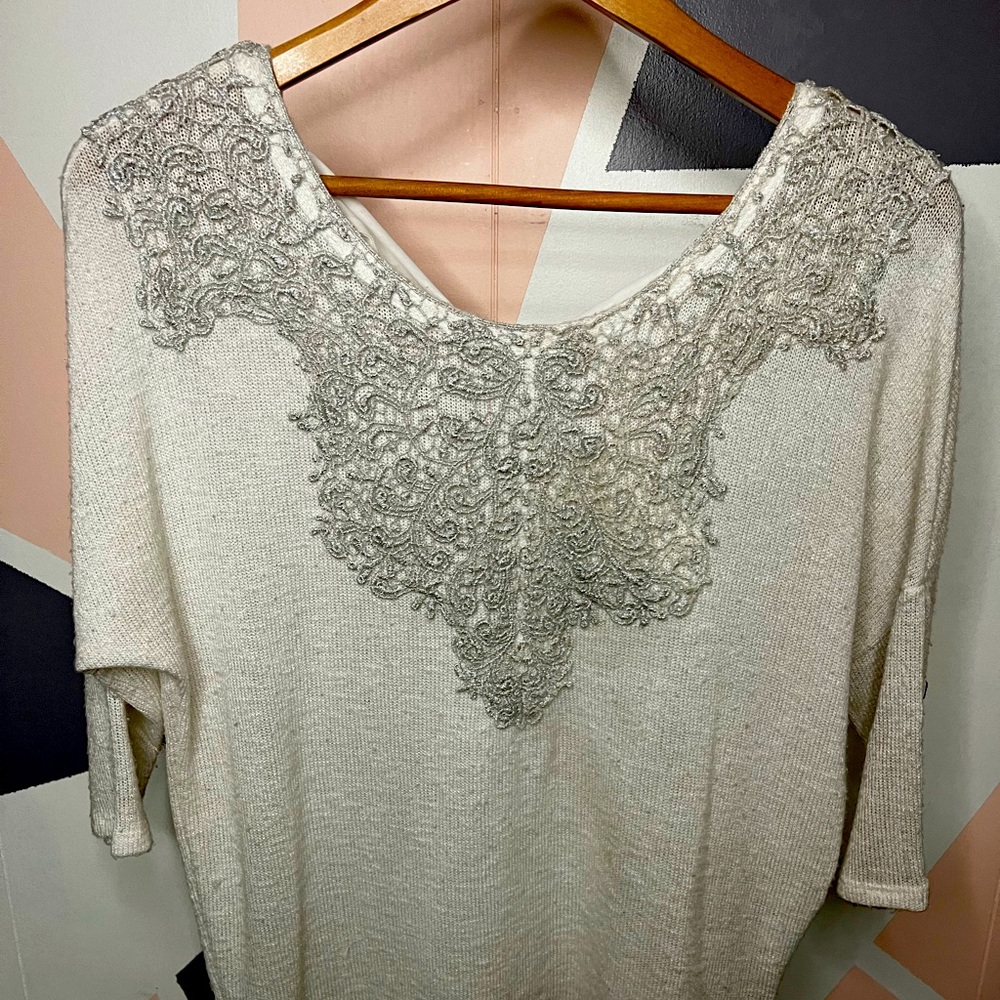 White 3/4 sleeve sweatshirt with embroidered neck line and tie back